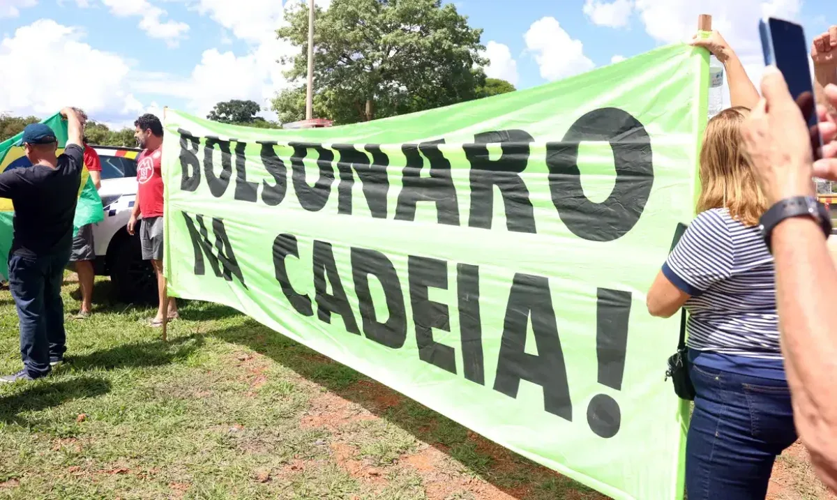 pessoas segurando uma grande faixa com a frase "BOLSONARO NA CADEIA!"