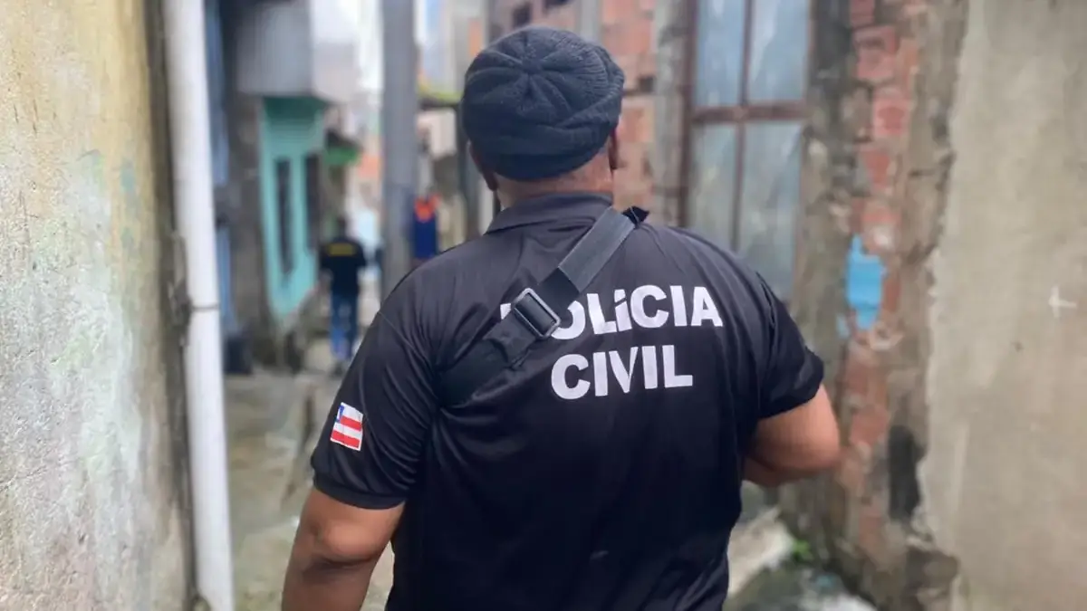 Policial civil andando em uma rua estreita em Salvador